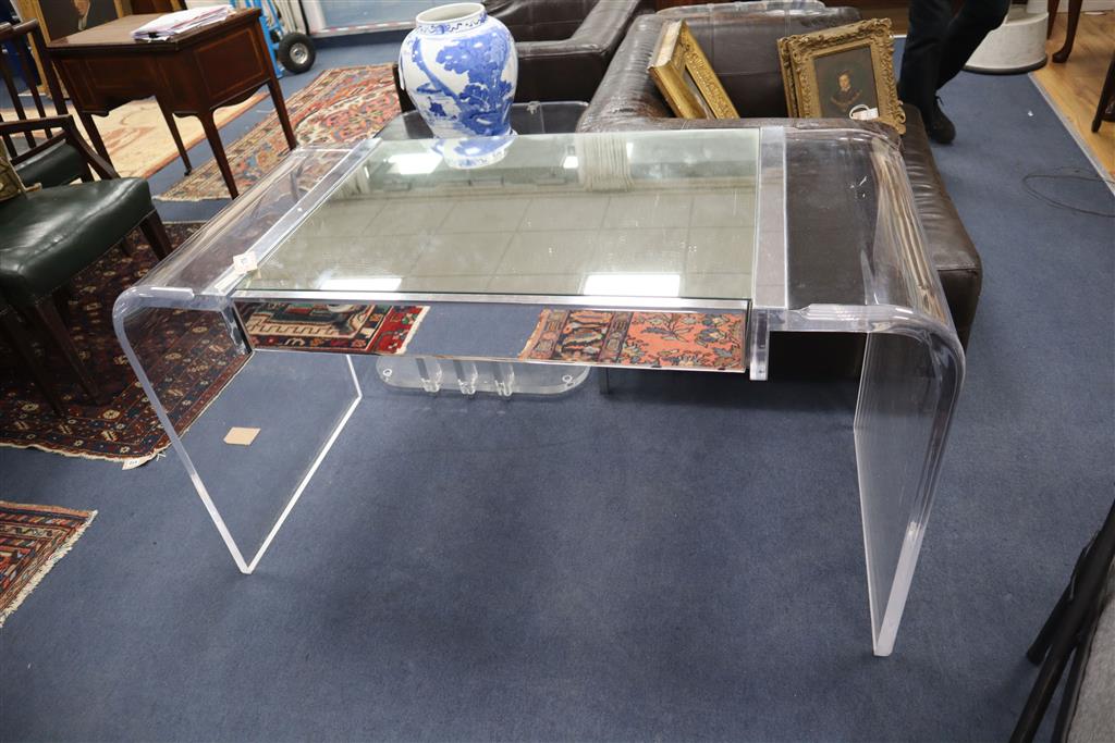 A 1970s Lucite desk with part mirrored top, width 130cm, depth 60cm, height 73cm